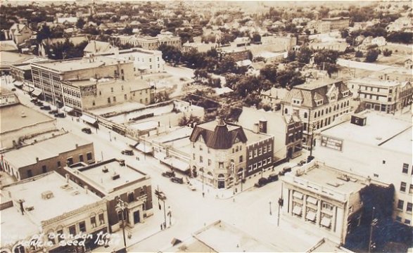 1934 View from McKenzie Seeds building ~ Wheat City Business College centre ~ Olympia Cafe left ~ Can. Bank Commerce right